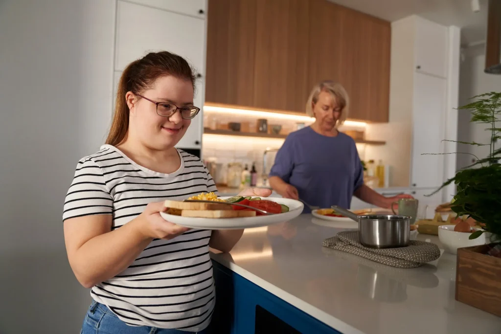 Disabled woman making breakfast with support worker