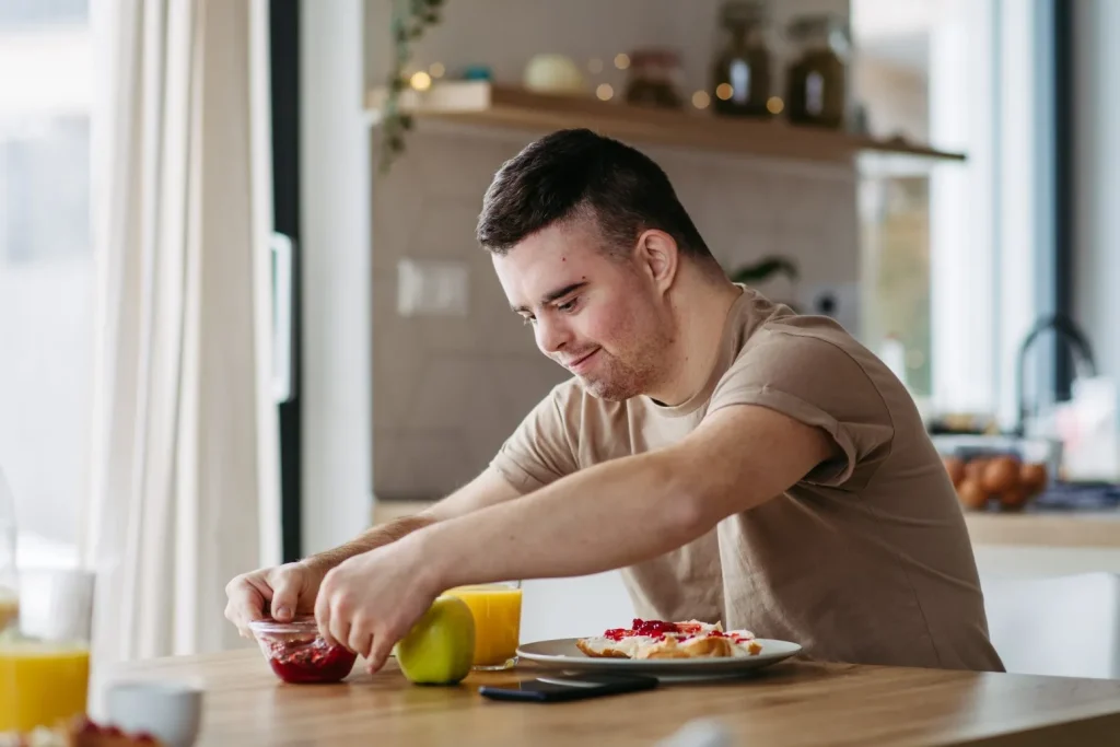 Disabled man having breakfast at kitchen table