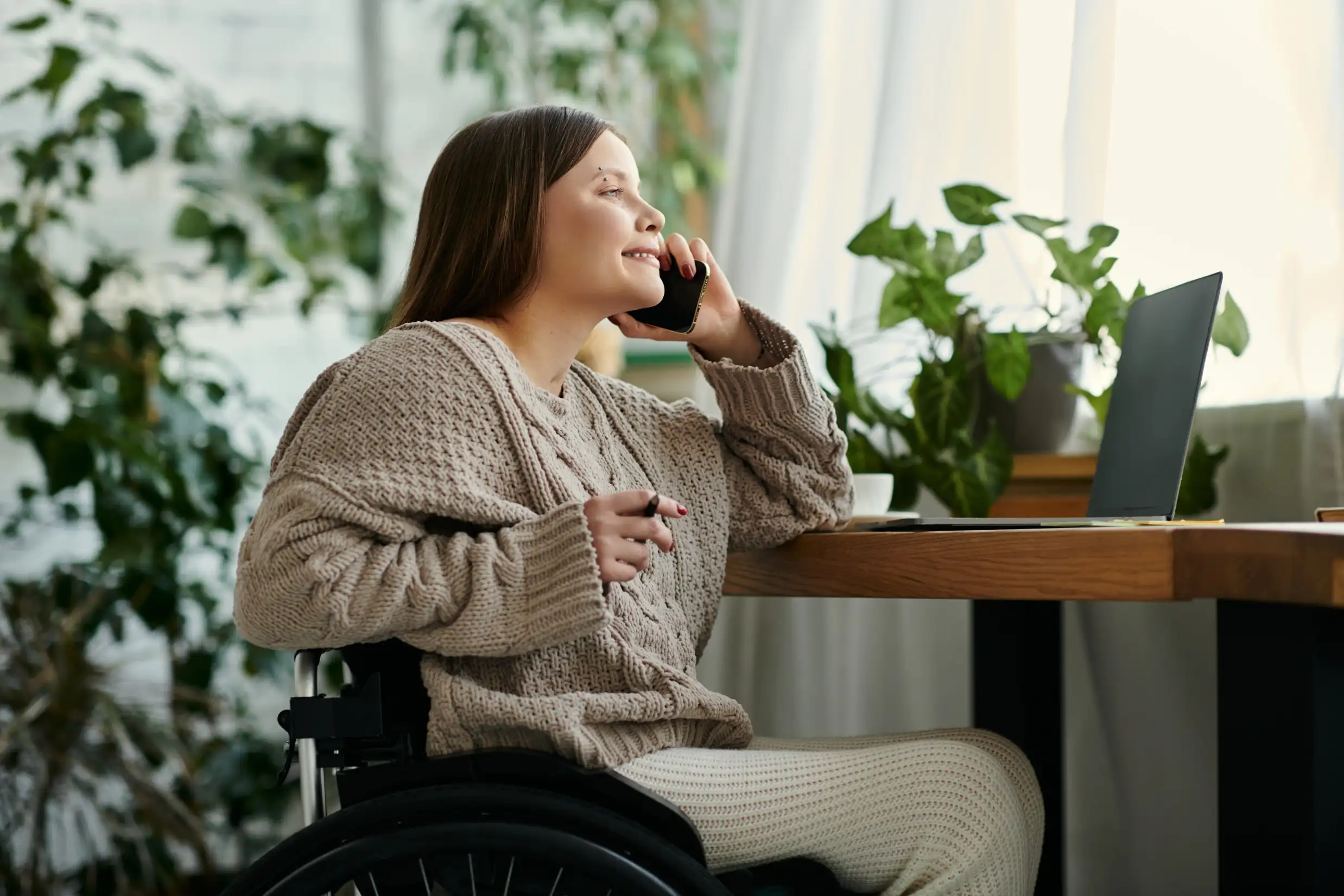 Disabled woman in wheelchair making phone call