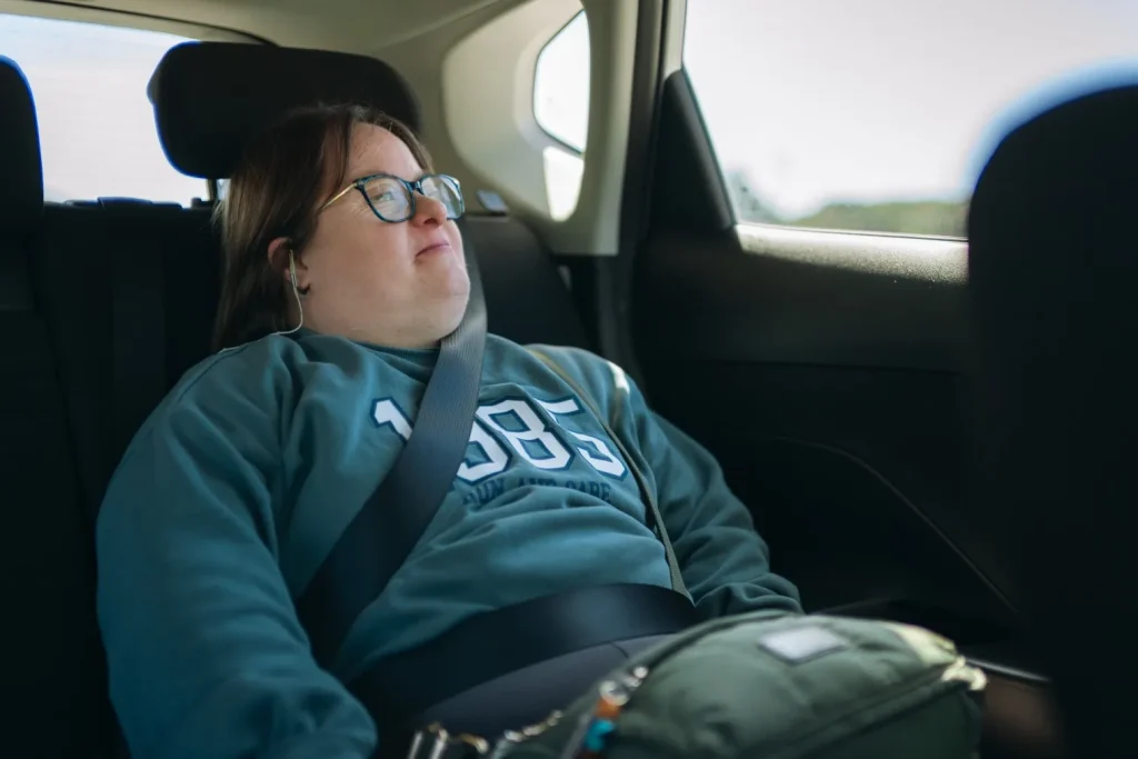 Disabled woman in the back seat of car